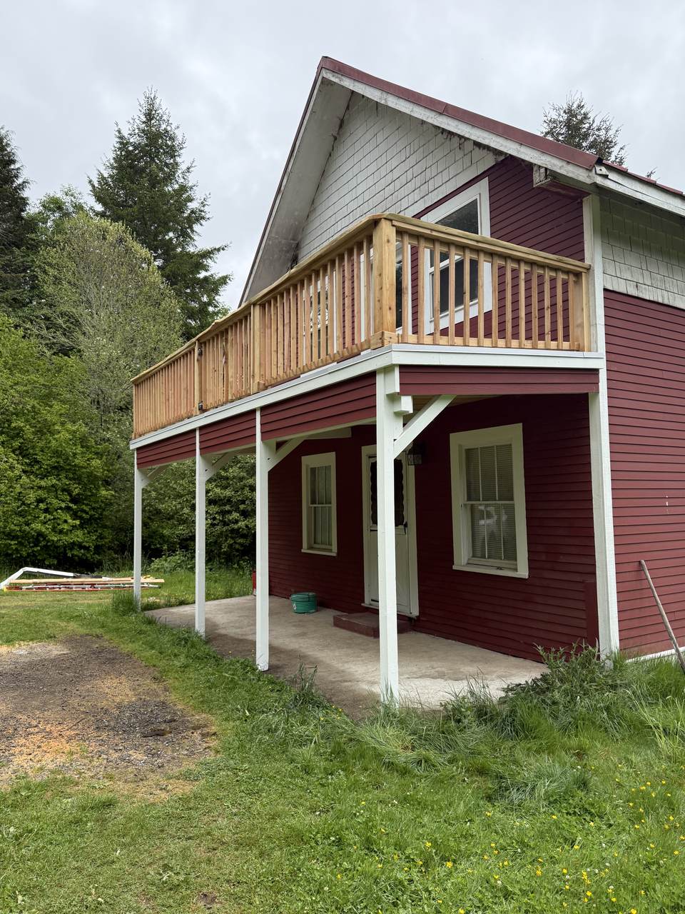 The same deck with a new cedar railing and rebuilt painted trim below