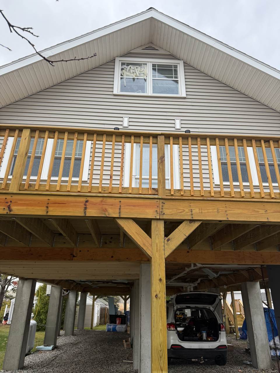 New deck framing and railing on a coastal Maine home raised on concrete piers